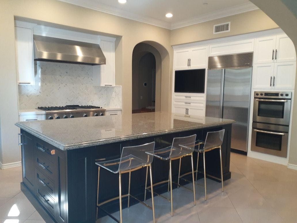 Dark kitchen island with pendant lighting