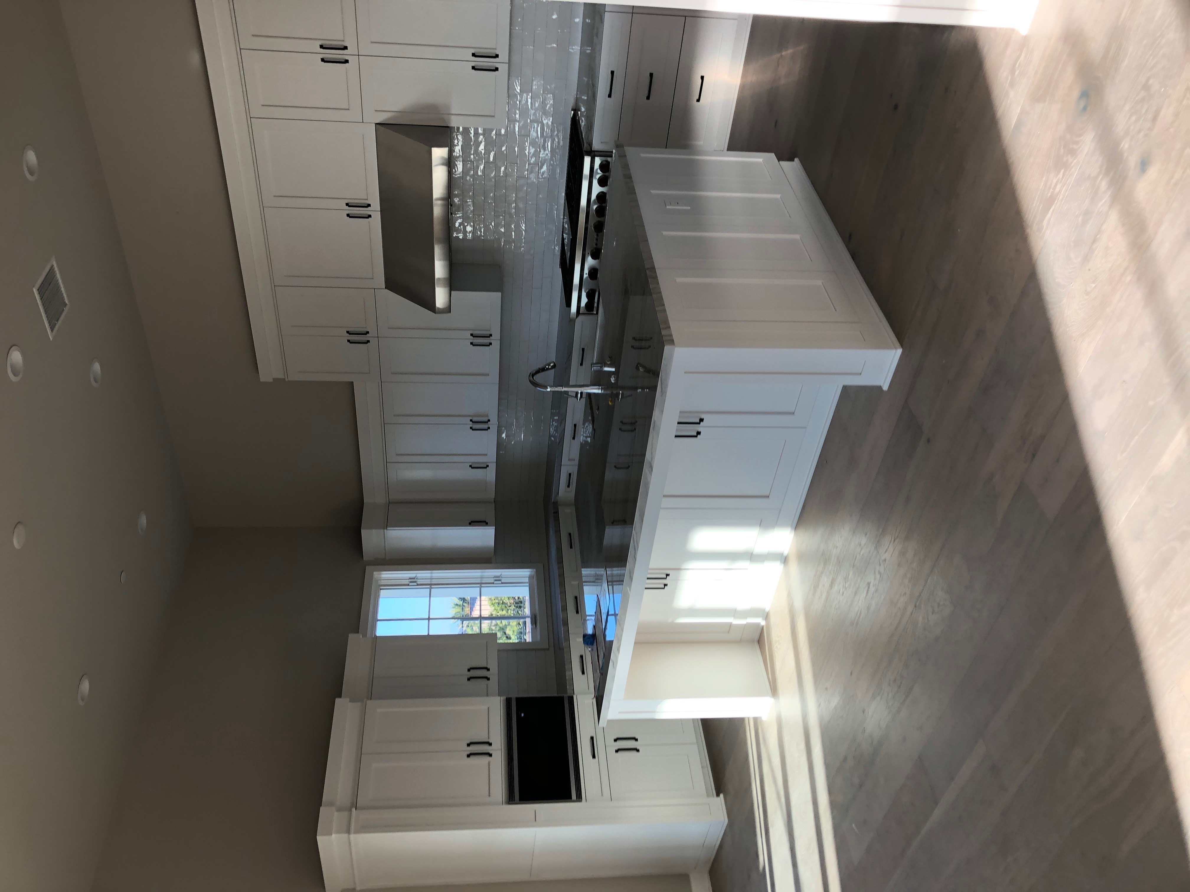 White kitchen with marble island